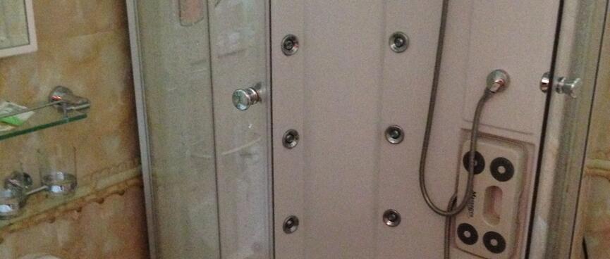 A round shower with six jets in the walls.