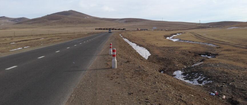 Snow in gullies along the side of the road.
