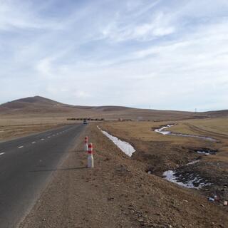 Snow in gullies along the side of the road.