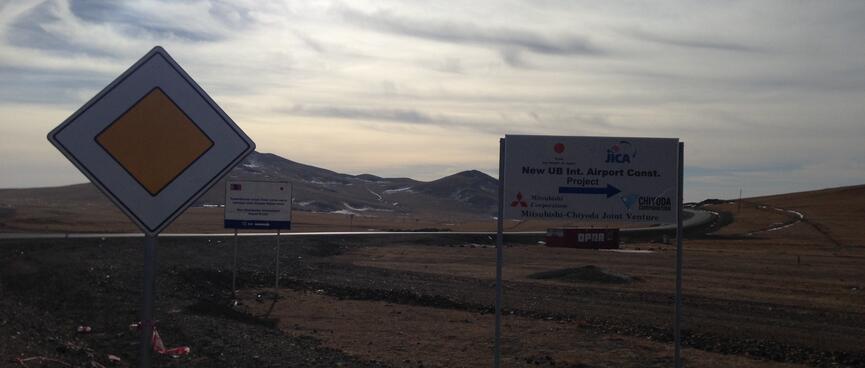 A sign for the New UB Int Airport Const Project, a Mitsubishi-Chiyoda Joint Venture.
