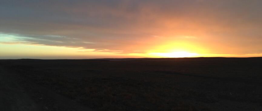 The sun sets in a fierce orange glow.