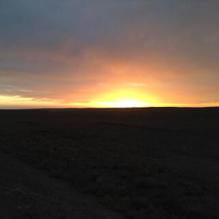 The sun sets in a fierce orange glow.