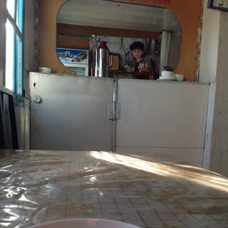 A plastic table cloth and beyond that a hinged wall and a large mirror.