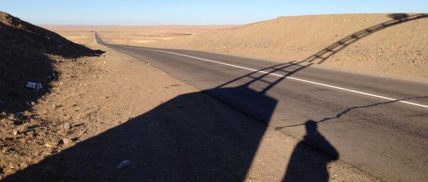 Black shadows cast by the arched gateway to Mandalgovi.