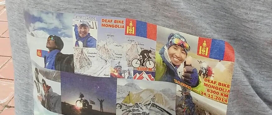 The back of a custom printed t-shirt is covered in travel photos.