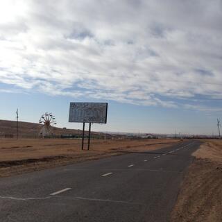A roadside billboard with two phone numbers on it.