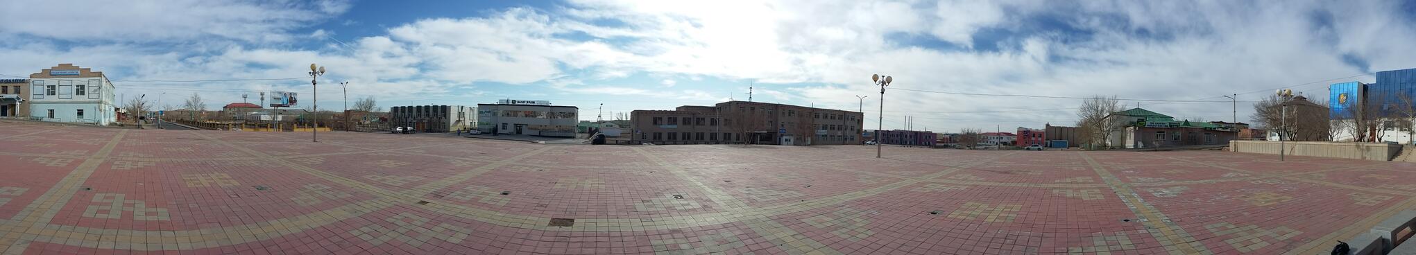 A red brick town square covered in yellow grid lines and repeating motifs. 