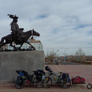 A statue of a rider on a horse above our bikes.