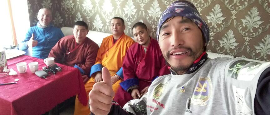 A selfie of two cyclists and the three monks.