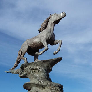 A statue of a stallion kicking its front legs into the air.