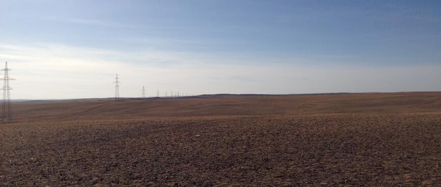To my left, a line of tall power pylons extends as far as the eye can see.