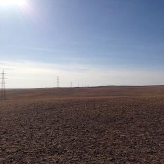 To my left, a line of tall power pylons extends as far as the eye can see.