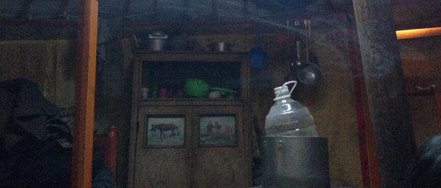 A frozen water bottle in a pot on top of the ger stove.