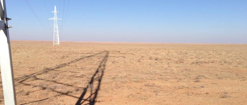 Power pylons and their shadows.