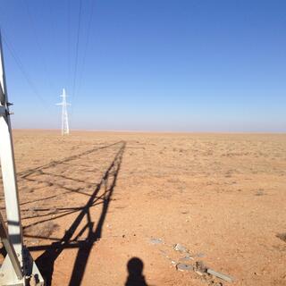 Power pylons and their shadows.