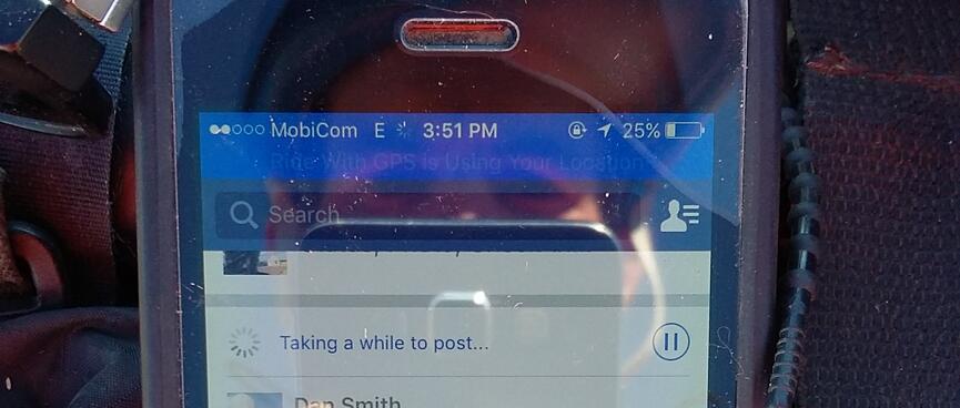 Facebook shows the message ʼTaking a while to post...ʼ.