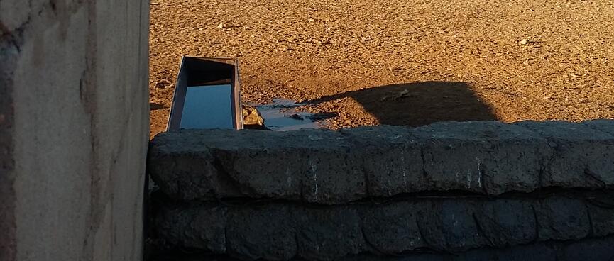 A metal trough containing water.