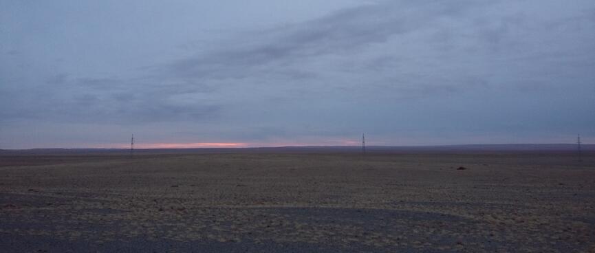 Grey sky with a sliver of pink at the horizon.