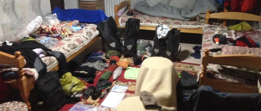 My gear is spread out on the floor and beds of my motel room.