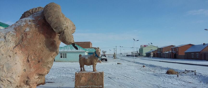 Concrete statues of a sheep and a goat.