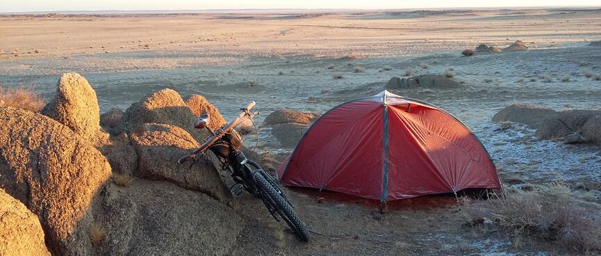 My tent is sits to the right of a pile of small boulders.