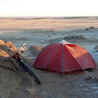 My tent is sits to the right of a pile of small boulders.