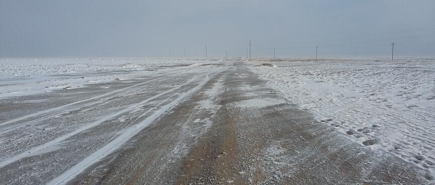 Snow smears on a dirt road resemble the Shroud of Turin.
