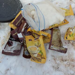 Brown and yellow sachets of breakfast drinks next to a steaming pot.