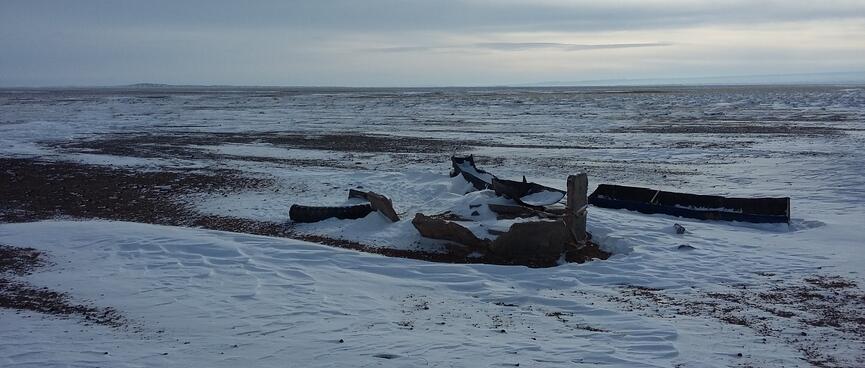 Several drinking troughs sit in the snow.