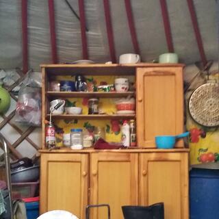 Wooden shelves with three shelves and a cupboard on top and three cupboards below.