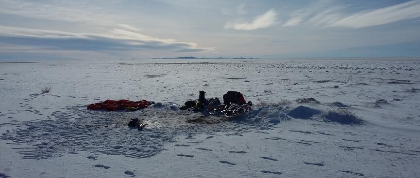 Footprints surround my belongings piled up in the snow.