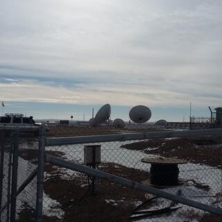 Two large satellite dishes and and three smaller ones.
