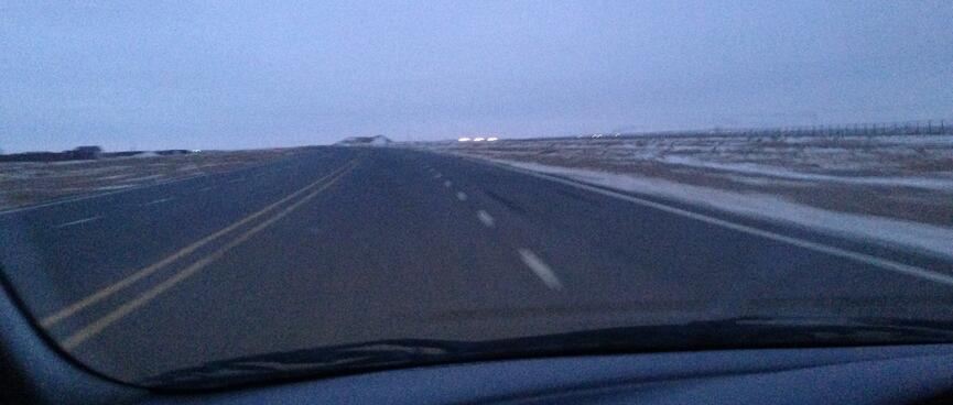A long straight stretch of four lane highway.