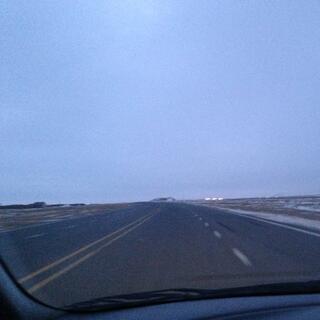 A long straight stretch of four lane highway.