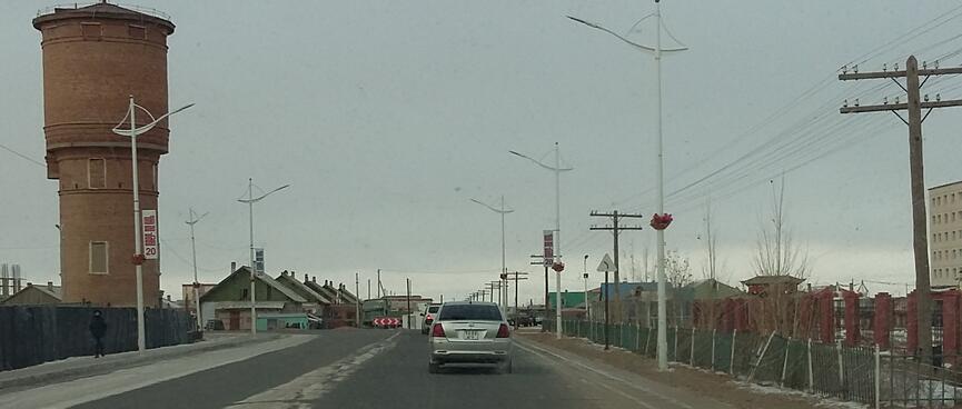 A round three storey tower on the side of the road.