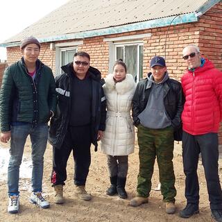 Group photo with a tall man, our driver, the woman in the white coat, Tommy and I.