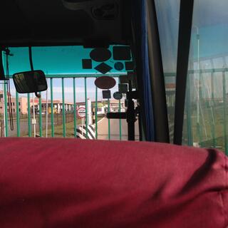 A green gate and a bilingual Stop sign stop us from covering the last short stretch of road into Russia.