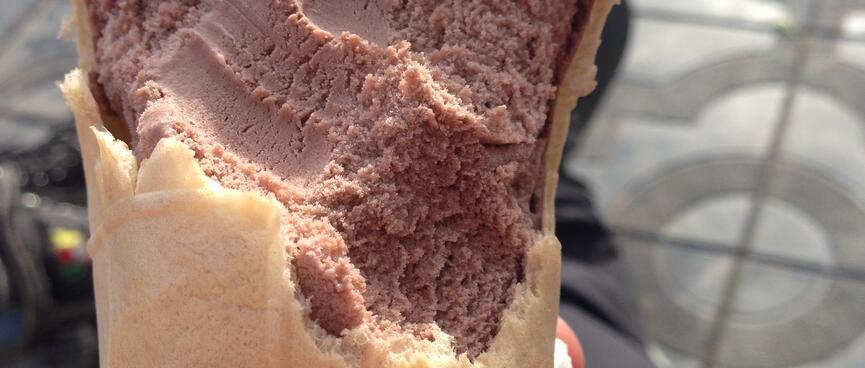 Cross section of a half eaten chocolate ice cream.