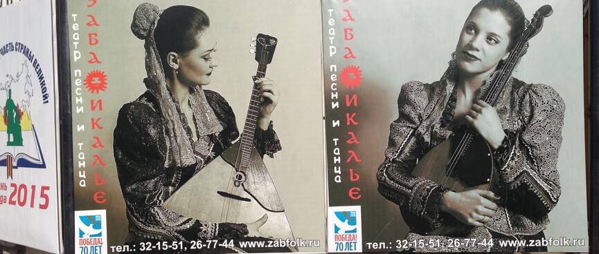 Pretty women cradle triangular and ovalular guitars in their arms.