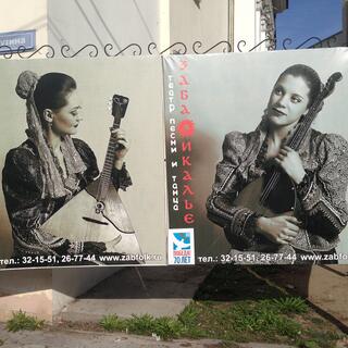Pretty women cradle triangular and ovalular guitars in their arms.