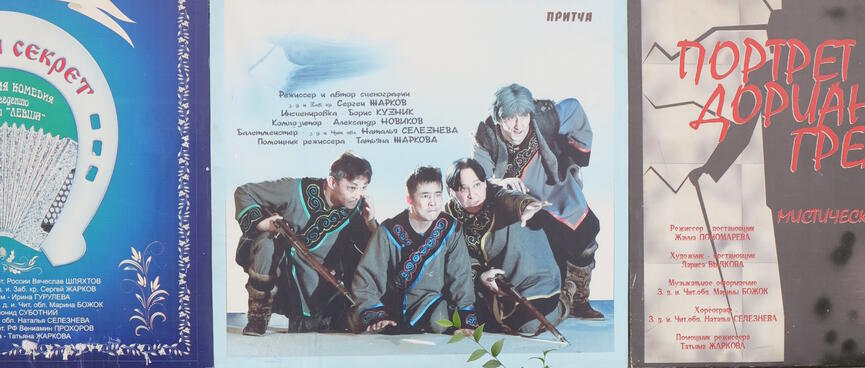 Soldiers wearing cloaks with ornate hemming whisper amongst themselves.