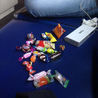 Wanna sits next to a large pile of candy.