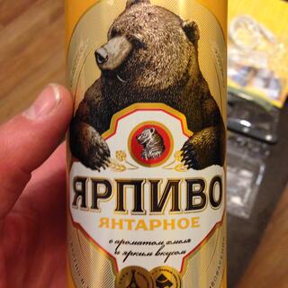 A tall golden can features a sketch of a brown beer.