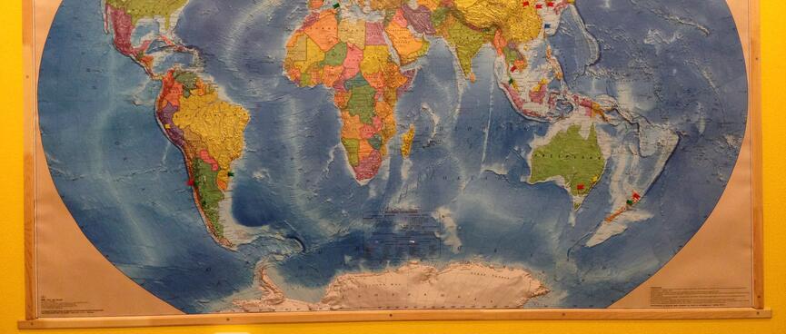 A small green flag is pinned to my hometown on a world map.