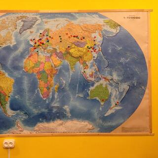 A small green flag is pinned to my hometown on a world map.