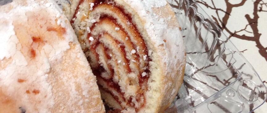 A jam roll and a cup of Chinese tea.