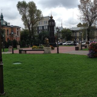 A paved path marks the boundary of a pedestrian square filled with enigmatic art, in Irkutsk.