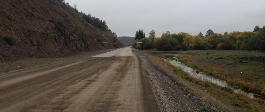 The dirt road becomes sealed.