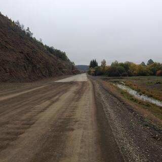 The dirt road becomes sealed.