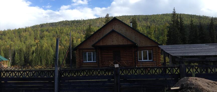 Stacked triangles form the profile of a wooden house.